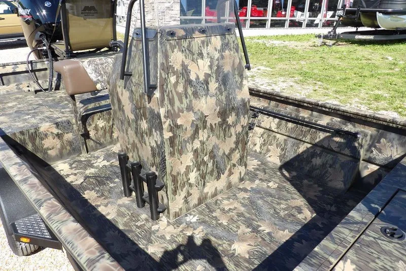 Slide: The Image of 2026 Crestliner 1860 Retriever CC Tunnel boat with camouflage design, featuring central console. - 15