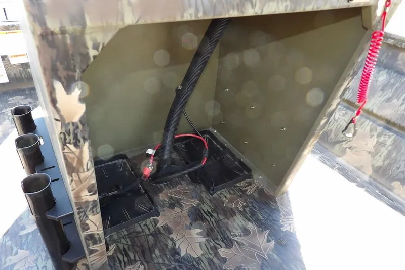 Slide: The Image of Interior view of 2026 Crestliner 1860 Retriever CC Tunnel boat, showcasing wiring and camouflage design. - 16