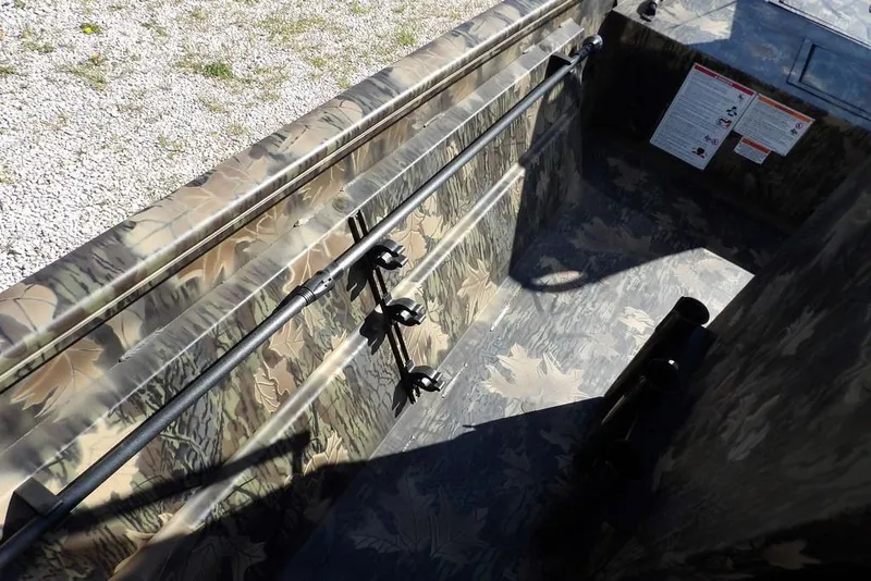 Slide: The Image of Interior view of 2026 Crestliner 1860 Retriever CC Tunnel boat with camouflage design. - 18