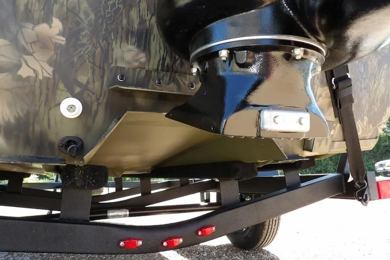 Slide: The Image of Close-up of 2026 Crestliner 1860 Retriever CC Tunnel boat hull and trailer. - 24