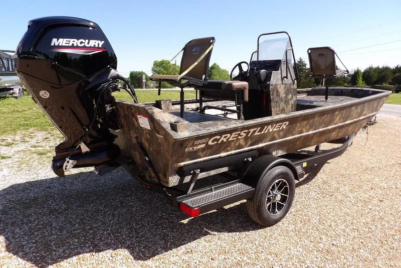Slide: The Image of 2026 Crestliner 1860 Retriever CC Tunnel boat with Mercury engine on trailer, camo design. - 27