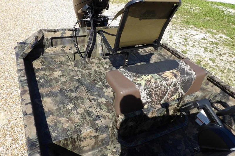 Slide: The Image of 2026 Crestliner 1860 Retriever CC Tunnel boat with camouflage seating and deck design. - 30