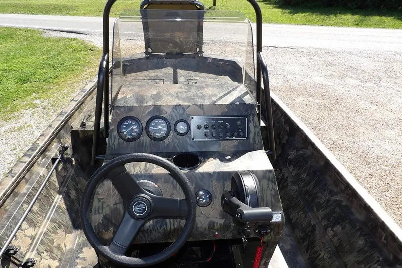 Slide: The Image of Interior view of 2026 Crestliner 1860 Retriever CC Tunnel boat dashboard with controls. - 32