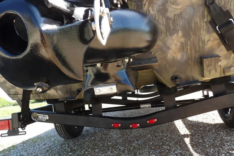 Slide: The Image of 2026 Crestliner 1860 Retriever CC Tunnel boat trailer close-up with camo design. - 39