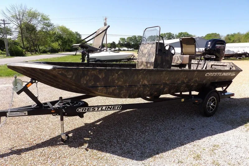 Slide: The Image of 2026 Crestliner 1860 Retriever CC Tunnel boat on trailer, camo design, parked outdoors. - 4