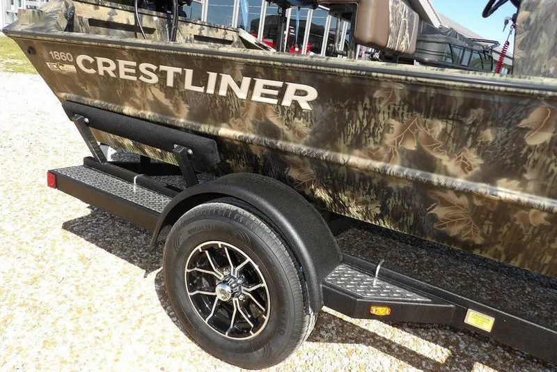 Slide: The Image of 2026 Crestliner 1860 Retriever CC Tunnel boat on trailer with camouflage design. - 40