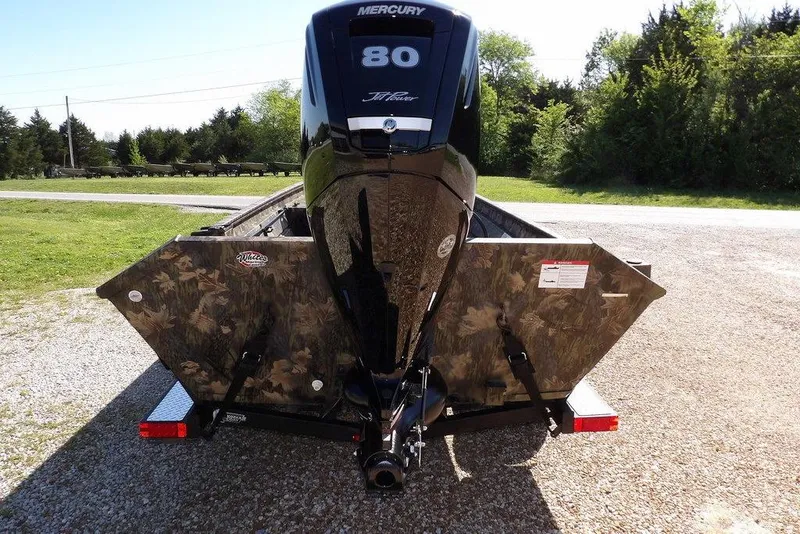 Slide: The Image of 2026 Crestliner 1860 Retriever CC Tunnel boat with Mercury 80 engine on a gravel driveway. - 6