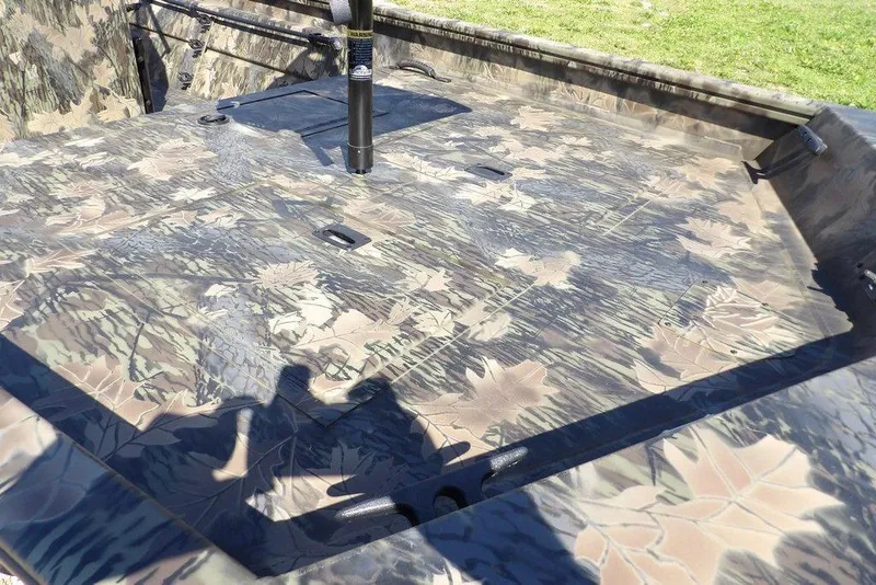 Slide: The Image of Crestliner 1860 Retriever CC Tunnel 2026 boat with camouflage deck design. - 8