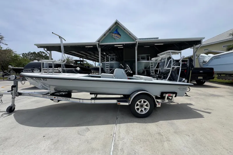 The Image of 2016 Hell's Bay Professional boat on trailer, parked outside a boat dealership. - 1