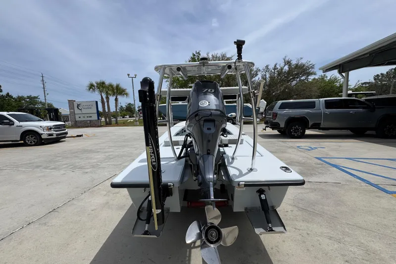 Slide: The Image of 2016 Hell's Bay Professional boat with motor, parked in a lot under a clear sky. - 12