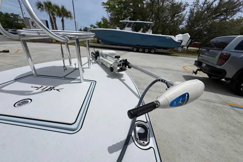 Slide: The Image of 2016 Hell's Bay Professional boat with trolling motor in a parking lot. - 19
