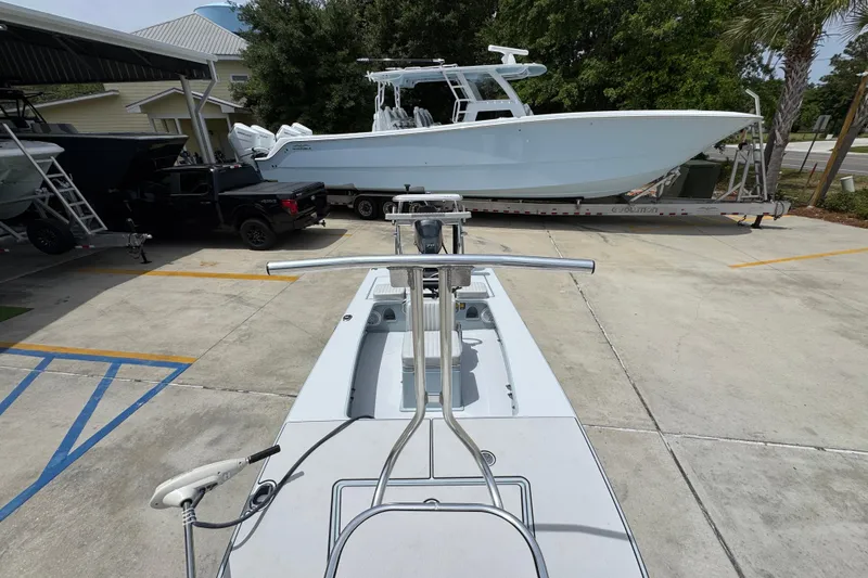 Slide: The Image of 2016 Hell's Bay Professional boat parked in a marina with other vessels. - 22