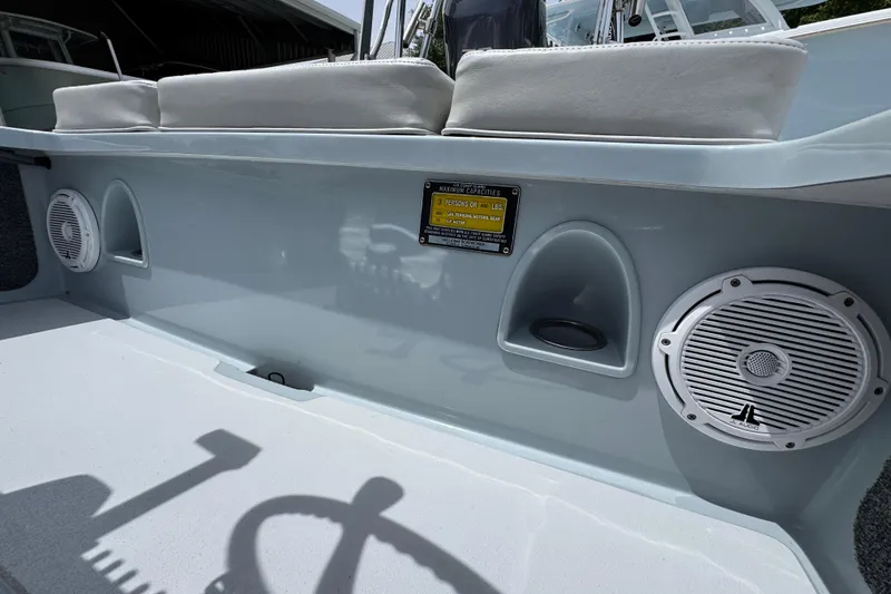 Slide: The Image of 2016 Hell's Bay Professional boat interior with speakers and seating. - 27