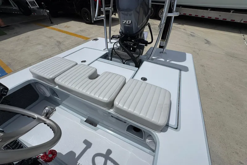 Slide: The Image of 2016 Hell's Bay Professional boat with Yamaha 70 engine, featuring cushioned seating and steering controls. - 28