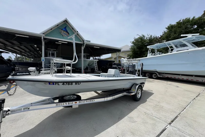 Slide: The Image of 2016 Hell's Bay Professional boat on trailer at marina, surrounded by other boats. - 3