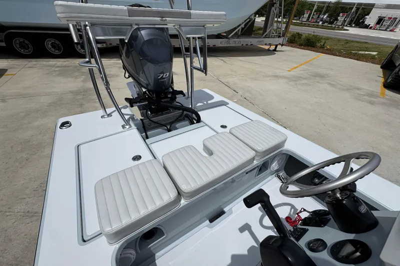 Slide: The Image of 2016 Hell's Bay Professional boat interior with steering wheel and motor, parked outdoors. - 30