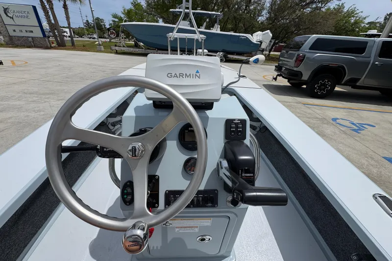 Slide: The Image of Hell's Bay Professional 2016 boat dashboard with Garmin navigation system and steering wheel. - 32