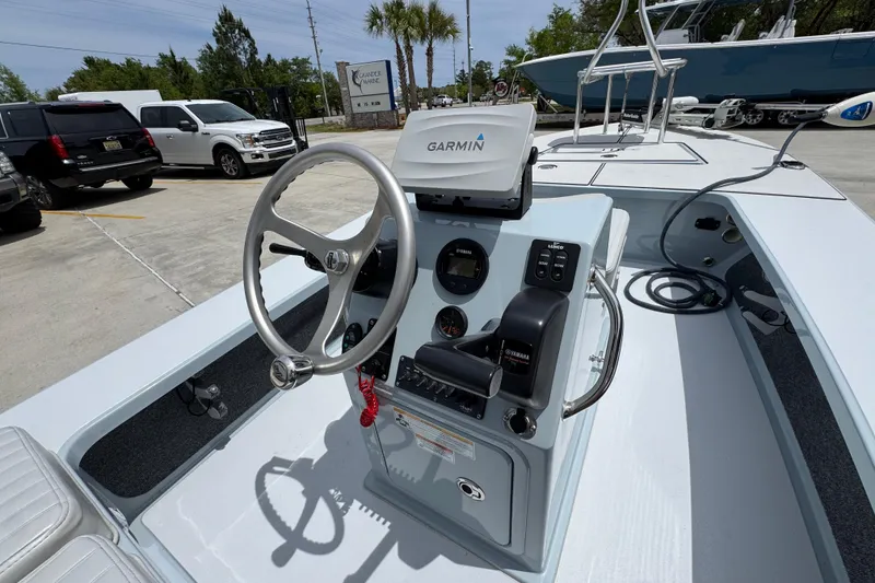 Slide: The Image of 2016 Hell's Bay Professional boat dashboard with Garmin navigation system and Yamaha controls. - 33