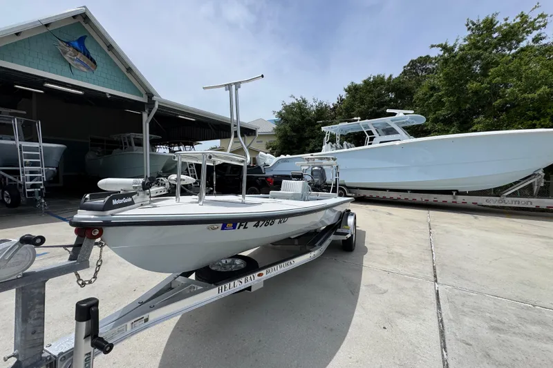 Slide: The Image of 2016 Hell's Bay Professional boat on trailer at marina, surrounded by other boats. - 4