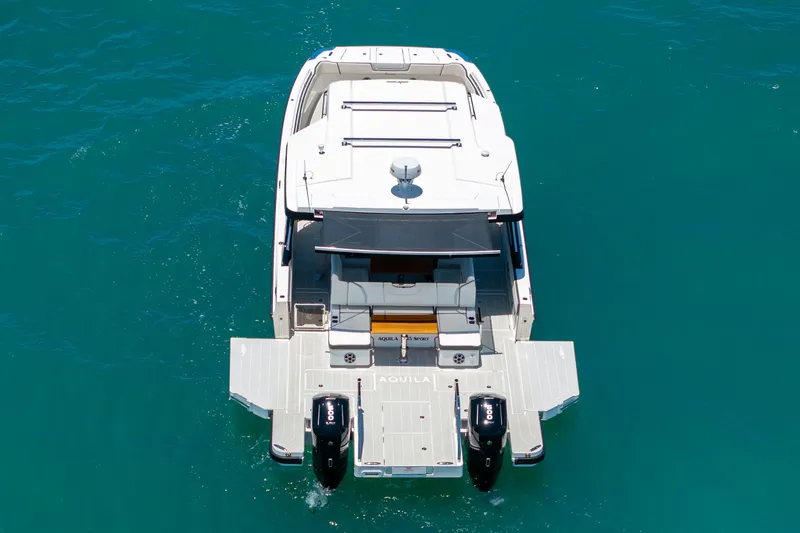 Slide: The Image of Aquila 45 Sport 2026 on blue water from above. - 1