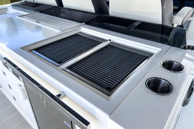 Slide: The Image of Aquila 45 Sport 2026: Luxury outdoor kitchen with grill and cup holders. - 11