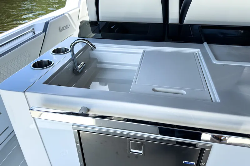 Slide: The Image of Aquila 45 Sport 2026 boat kitchen with sink and cutting board. - 12