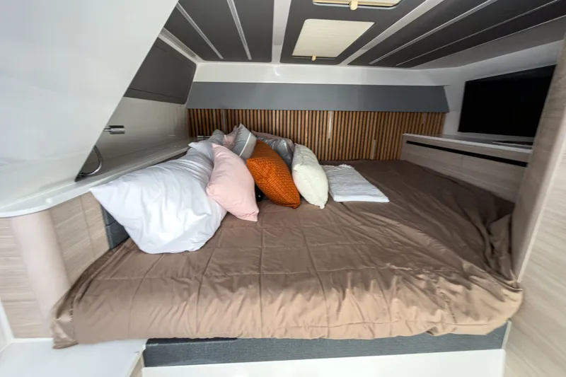 Slide: The Image of Interior of Aquila 45 Sport 2026 featuring cozy bed and pillows. - 19