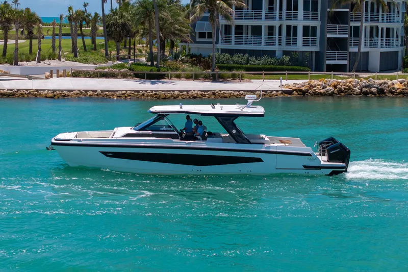 Slide: The Image of Aquila 45 Sport 2026 cruising on blue water near coastal scenery. - 3
