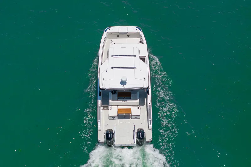 Slide: The Image of Aerial view of 2026 Aquila 45 Sport yacht on open water. - 31