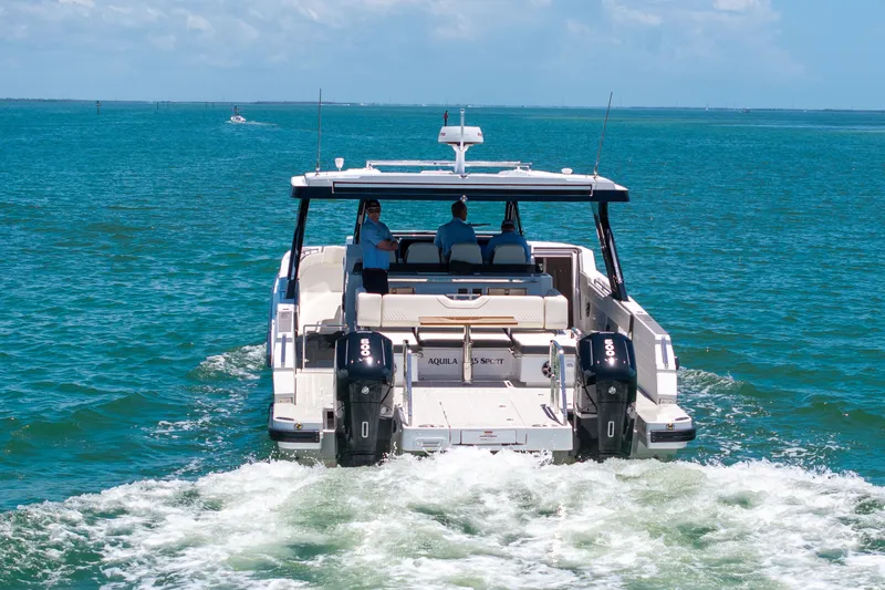 Slide: The Image of Aquila 45 Sport 2026 cruising on open sea, rear view. - 4