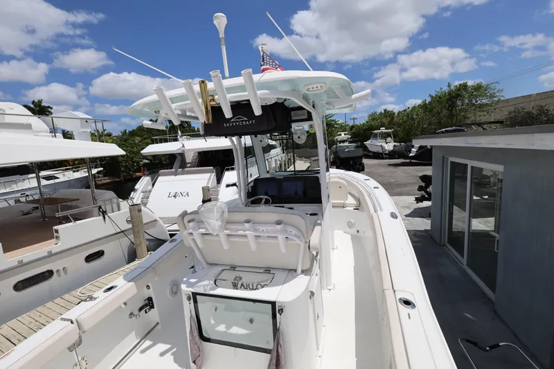 Slide: The Image of 2024 Sea Hunt Gamefish 25 boat docked, featuring spacious deck and modern equipment. - 10