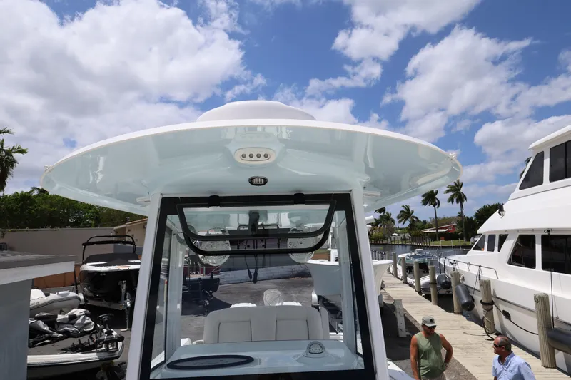 Slide: The Image of 2024 Sea Hunt Gamefish 25 boat docked under a clear blue sky. - 18