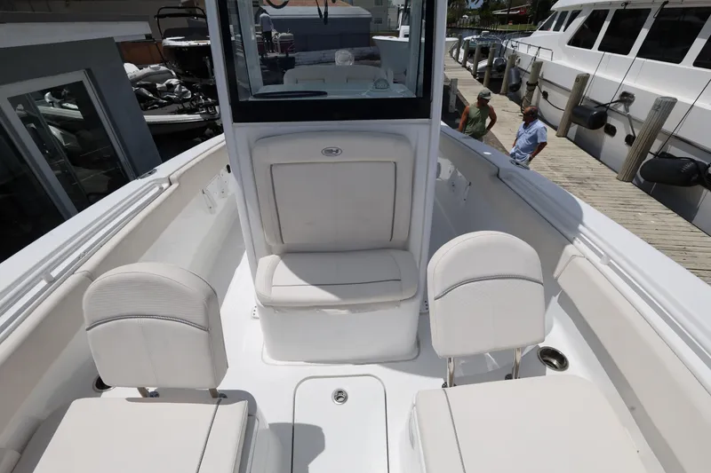 Slide: The Image of 2024 Sea Hunt Gamefish 25 boat interior with white seating and console. - 19