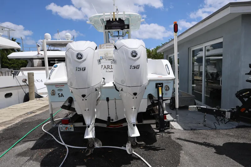 Slide: The Image of 2024 Sea Hunt Gamefish 25 with twin Yamaha 150 engines docked at marina. - 4