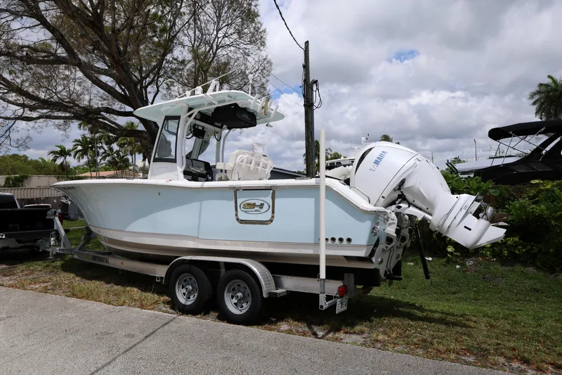 Slide: The Image of 2024 Sea Hunt Gamefish 25 boat on trailer with Yamaha outboard motor. - 8