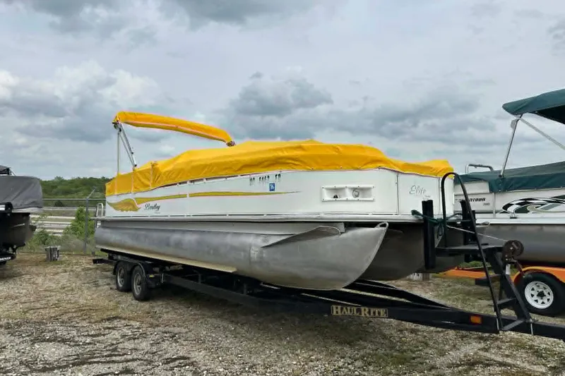 The Image of 2011 Bentley Pontoons 250/253 Elite Admiral with yellow cover on trailer. - 0