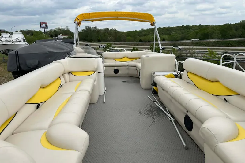 Slide: The Image of 2011 Bentley Pontoons 250/253 Elite Admiral with yellow and cream seating, docked outdoors. - 14