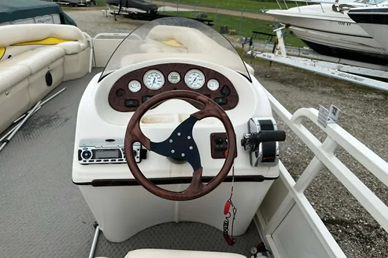 Slide: The Image of 2011 Bentley Pontoons 250/253 Elite Admiral dashboard with steering wheel and gauges. - 4