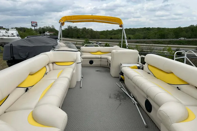 Slide: The Image of 2011 Bentley Pontoons 250/253 Elite Admiral with yellow and white seating, docked outdoors. - 5
