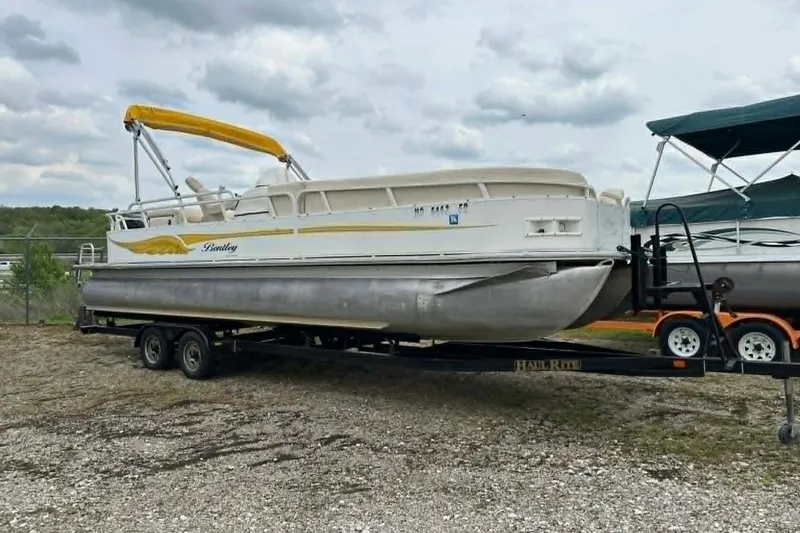 Slide: The Image of 2011 Bentley Pontoons 250/253 Elite Admiral on trailer, featuring yellow canopy. - 7
