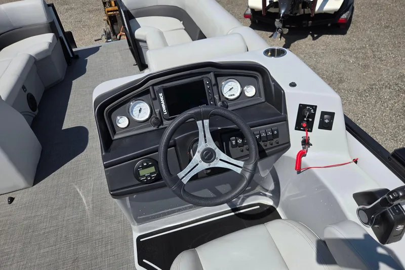 Slide: The Image of 2022 Bentley Pontoons 240 Navigator dashboard with steering wheel and control panel. - 10