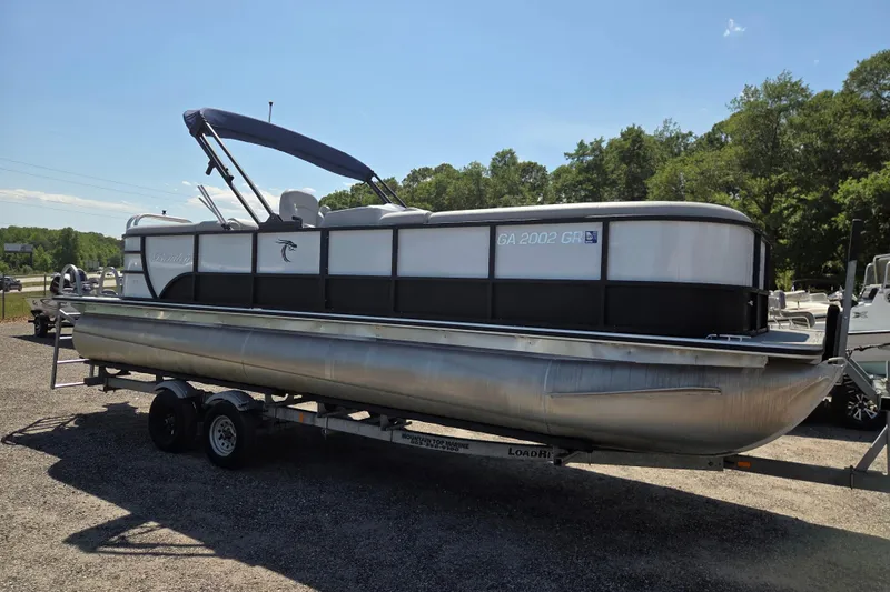 Slide: The Image of 2022 Bentley Pontoons 240 Navigator on trailer, parked outdoors under clear sky. - 3