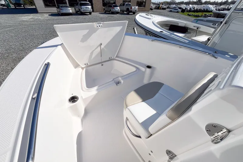 Slide: The Image of 2018 Robalo R180 Center Console boat interior with open storage compartment and seating. - 10