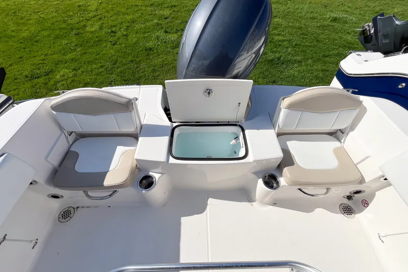 Slide: The Image of 2018 Robalo R180 Center Console boat interior with seating and storage. - 7