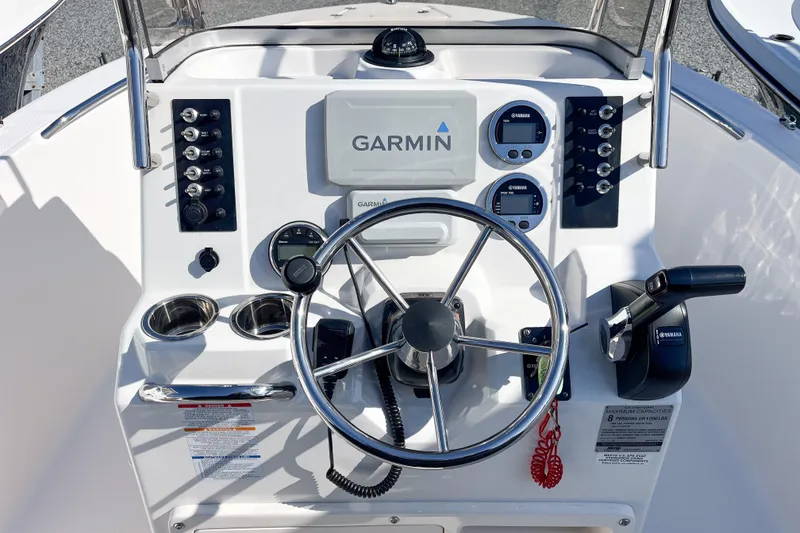 Slide: The Image of 2018 Robalo R180 Center Console dashboard with Garmin navigation system and Yamaha controls. - 8