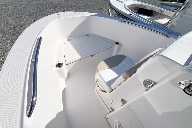 Slide: The Image of 2018 Robalo R180 Center Console boat interior with seating and storage. - 9