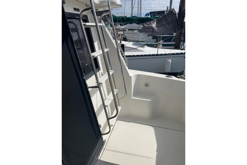 Slide: The Image of 1996 Bayliner 3255 Avanti boat deck with ladder, docked at marina. - 14