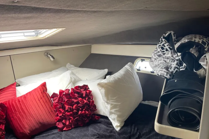 Slide: The Image of Cozy cabin interior of 1996 Bayliner 3255 Avanti with plush pillows and decorative accents. - 22