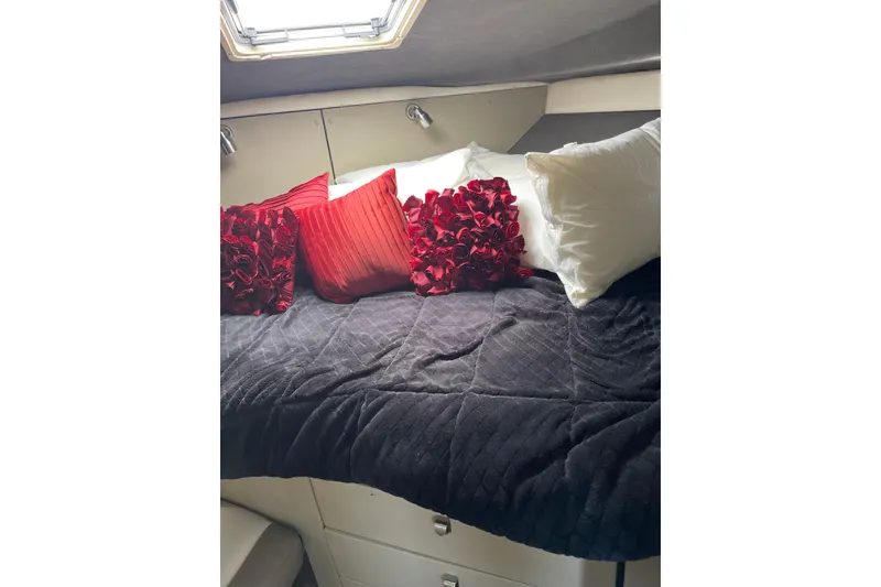 Slide: The Image of Cozy cabin interior of 1996 Bayliner 3255 Avanti with plush pillows and soft bedding. - 23
