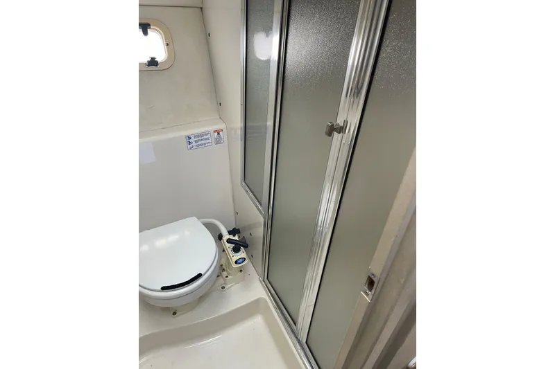 Slide: The Image of 1996 Bayliner 3255 Avanti boat bathroom with toilet and shower enclosure. - 25